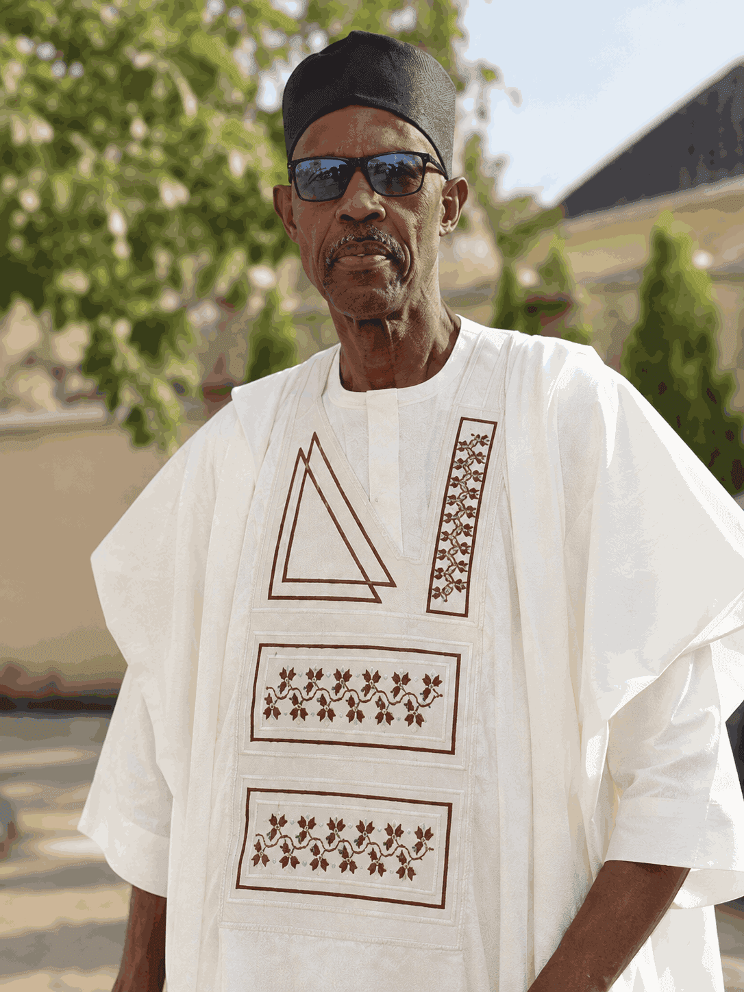 A gentleman wearing a detailed white agbada